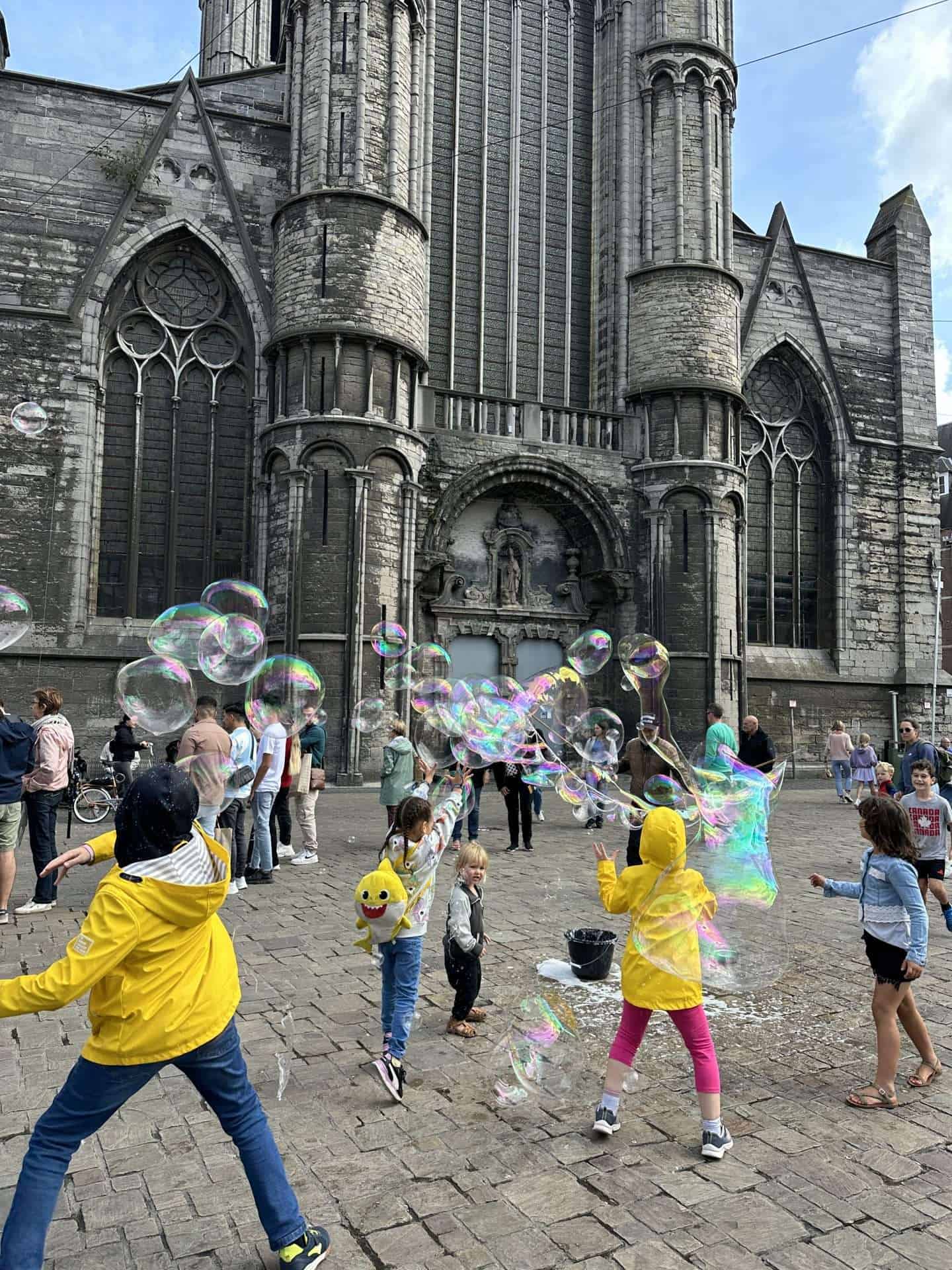 Ghent Saint Nicholas Cathedral - kids playing with bubbles