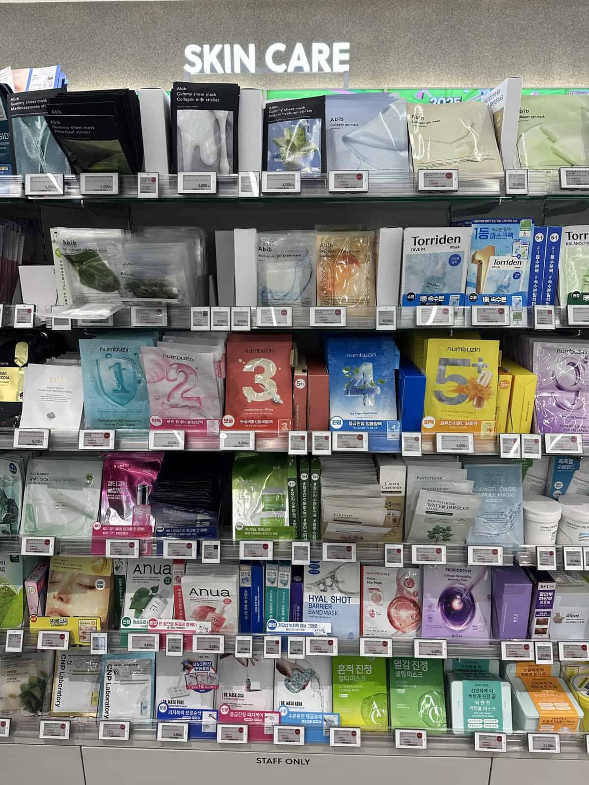 shelving full of different styles of sheet masks at store in Seoul Korea