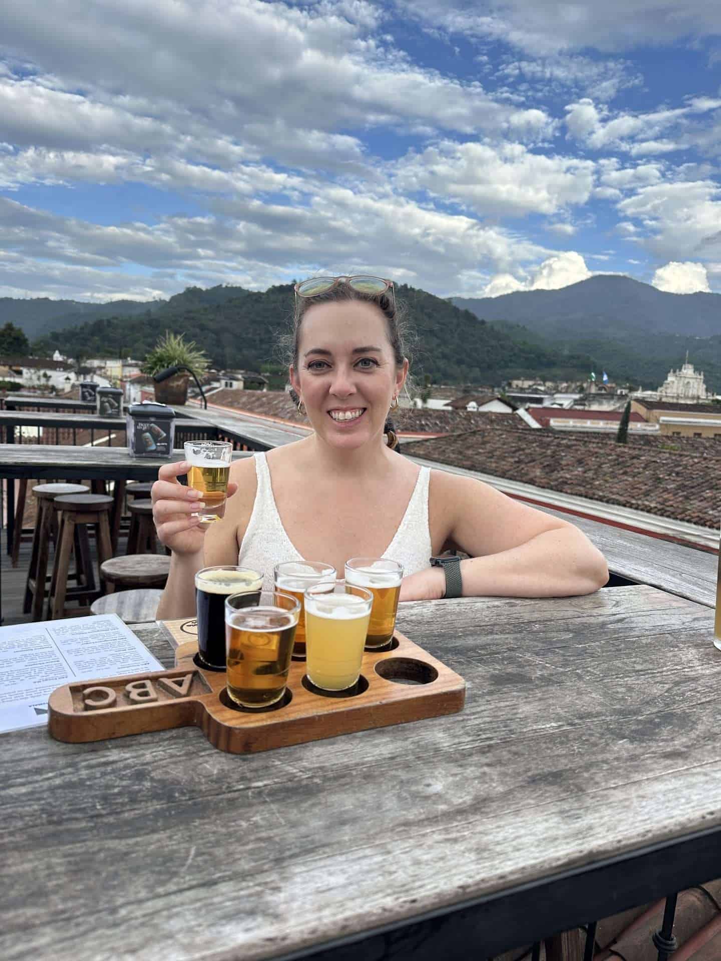 Carli with beer flight at Antigua Brewing Company - antigua guatemala bars