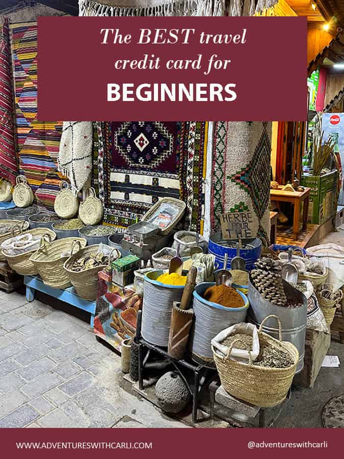 poster reading: Best Travel Credit Card for Beginners. moroccan souk with buckets of spices and hanging carpets in background image