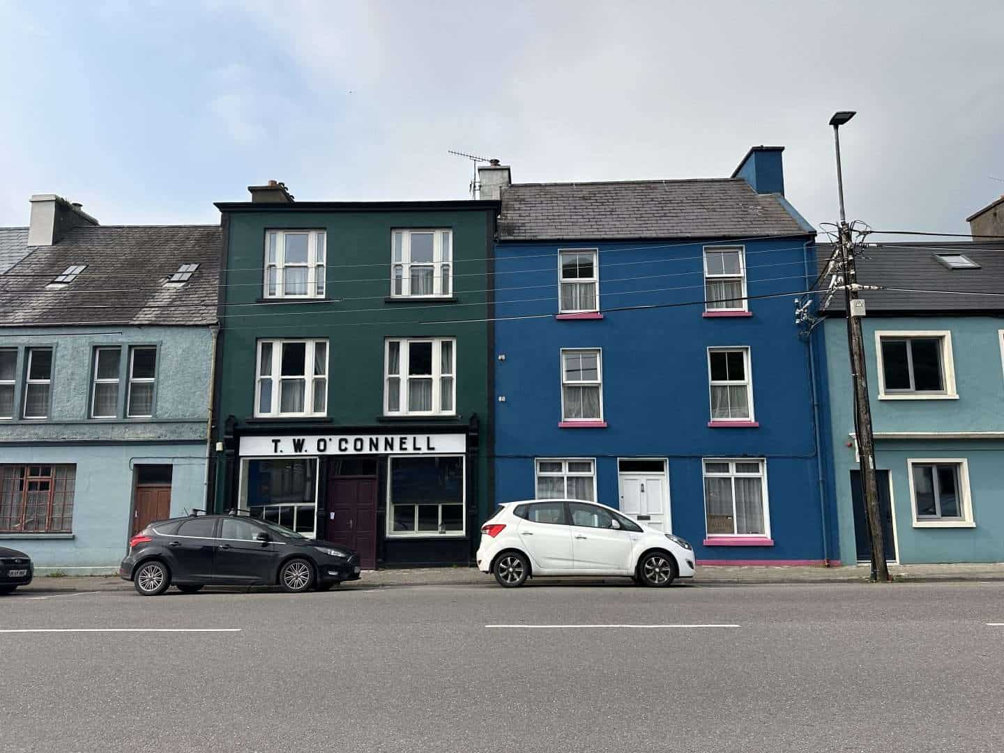 car parked in front of colorful buildings in ireland