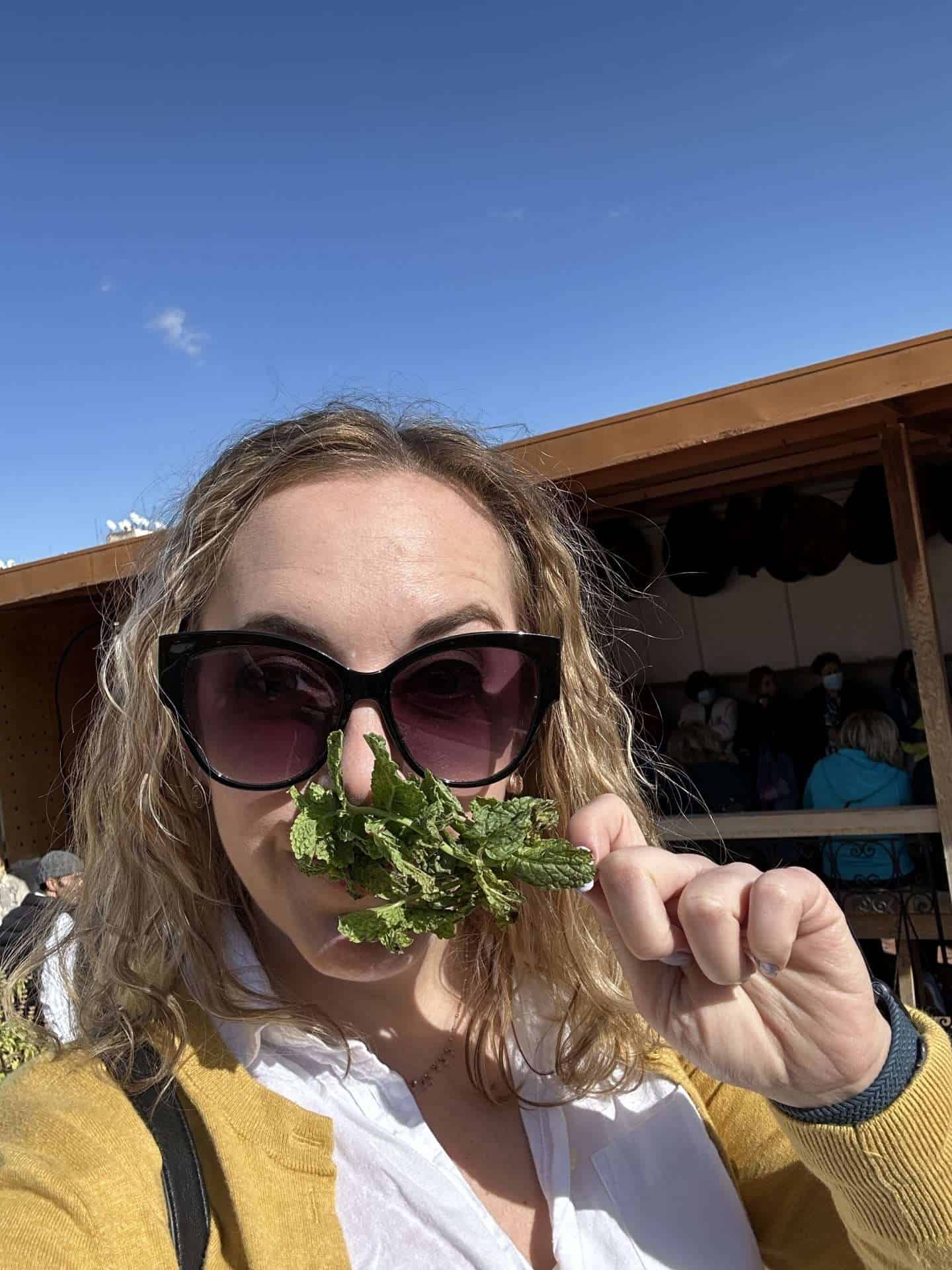 smelling mint leaves at fes tannery things to do in fes morocco