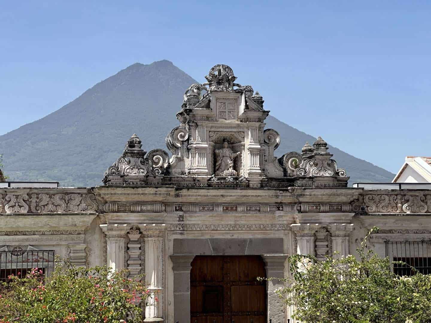 historic building with volcan de agua in background - antigua guatemala