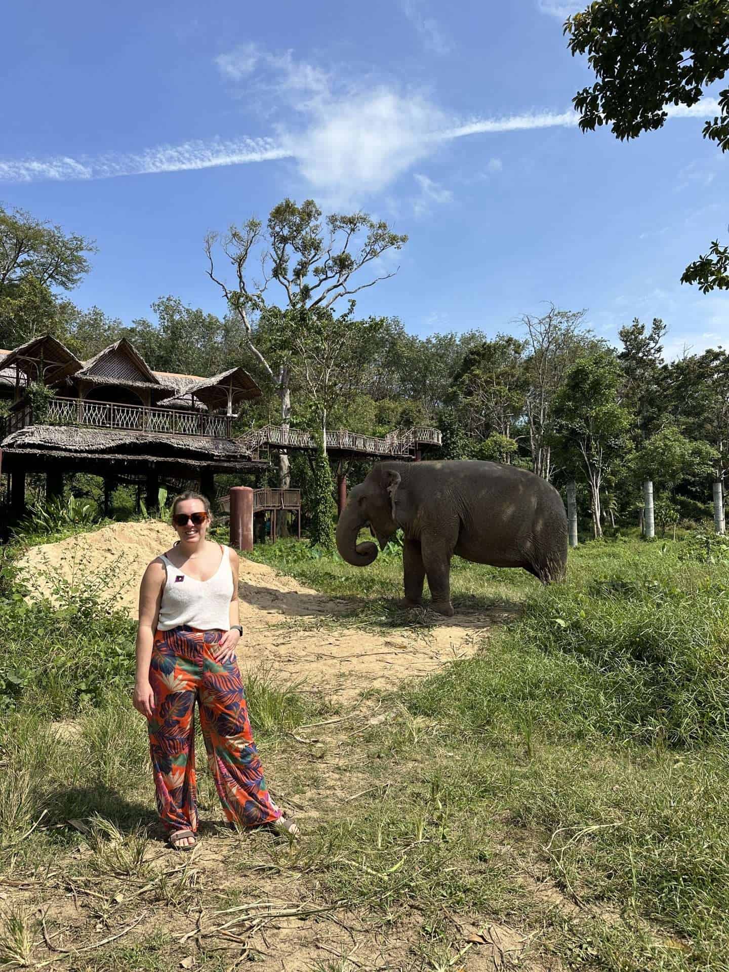 carli posing with an elephant at phuket elephant sanctuary - best elephant sanctuary in phuket