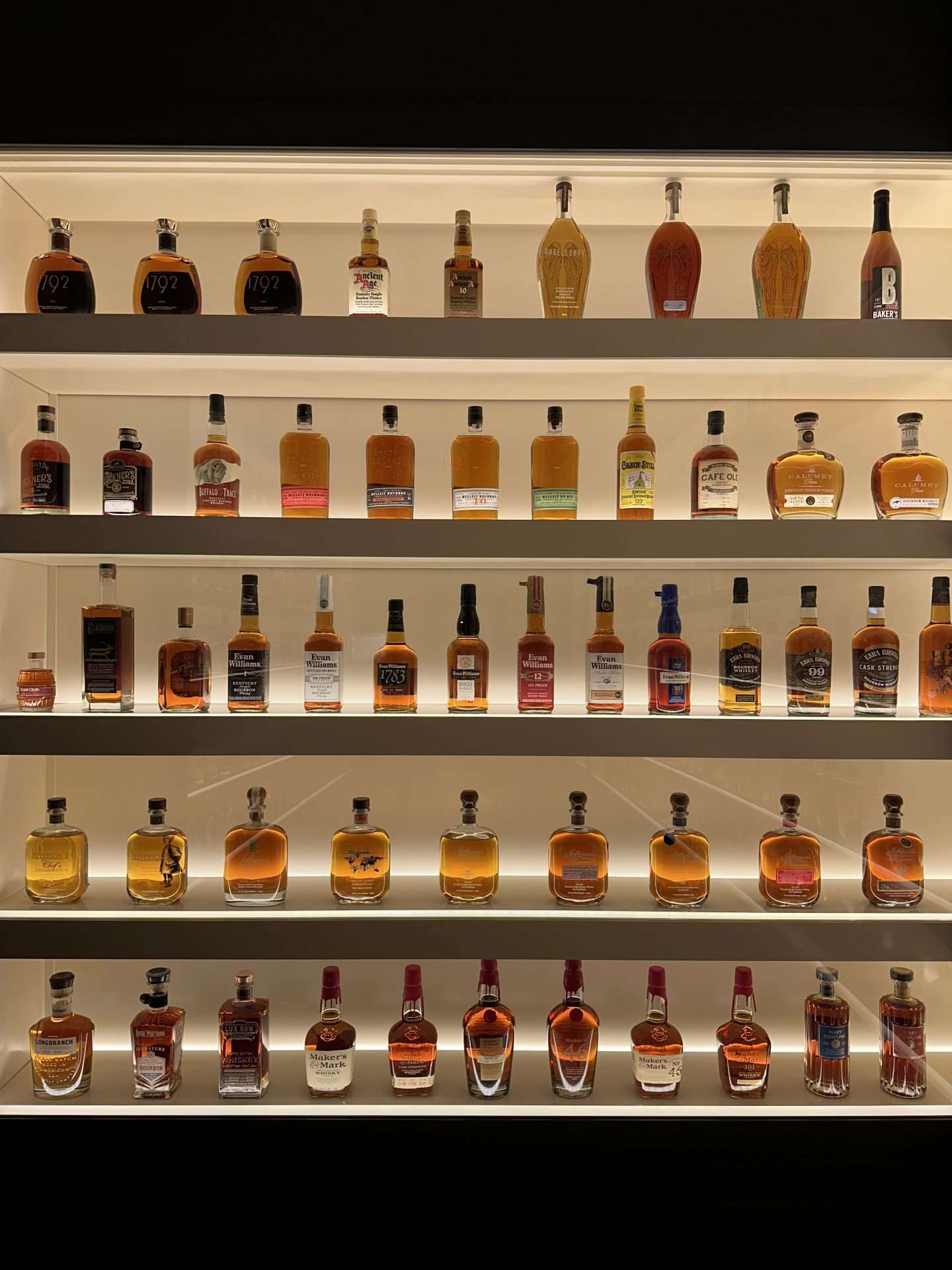wall of bourbon bottles at frazier history museum in louisville, ky
