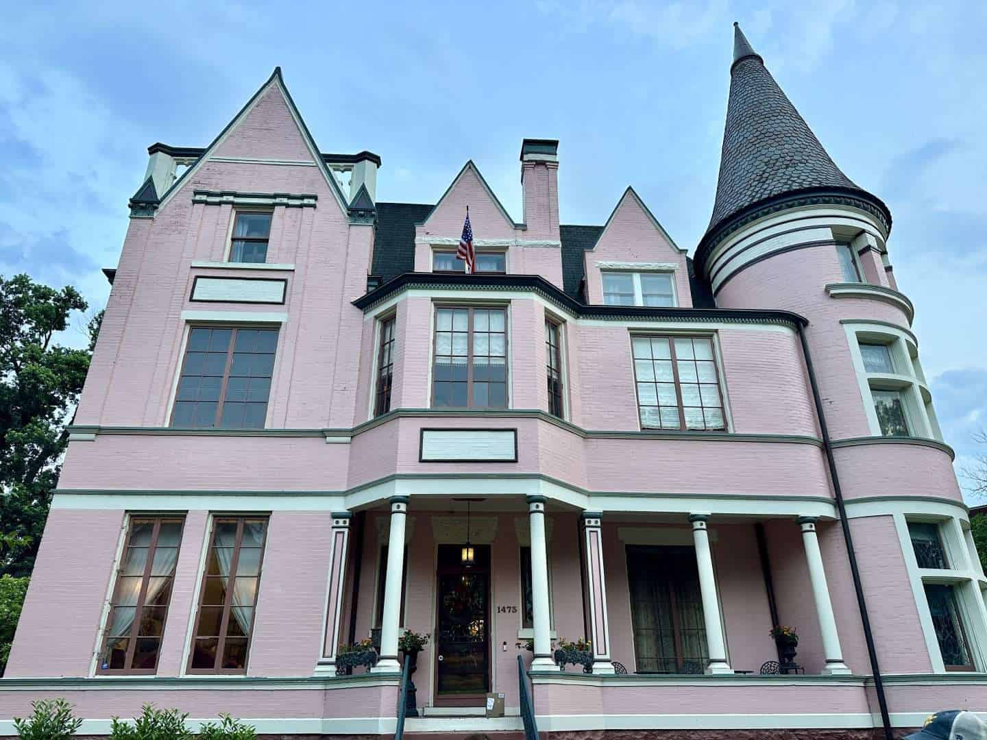 exterior of historic pink palace at dusk in old louisville