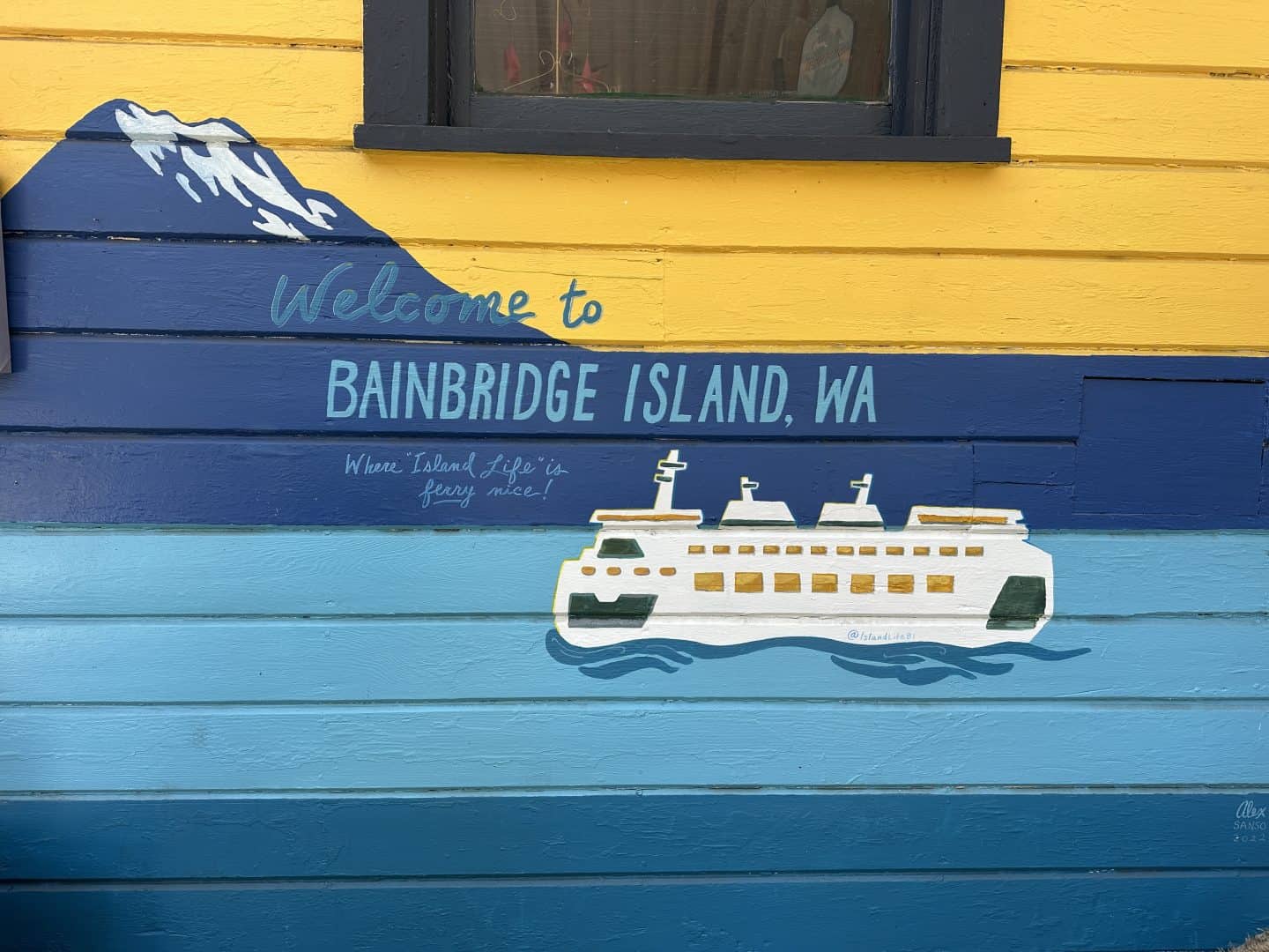 exterior wall mural with mt rainier and a ferry along the sound, visible during a day trip to bainbridge island