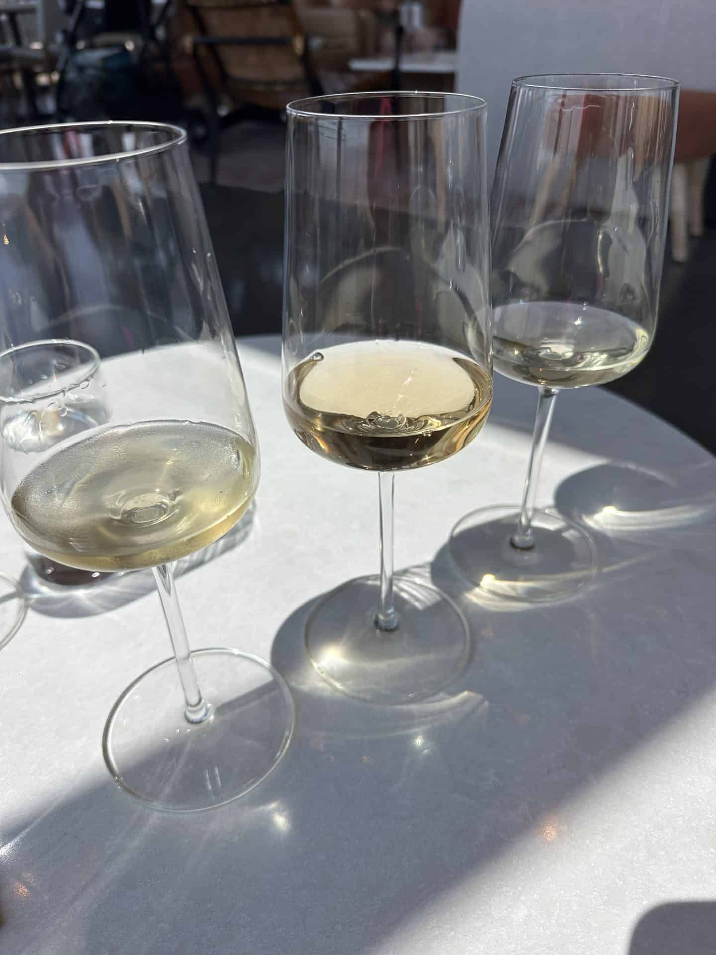 three glasses of white wine tasting flight