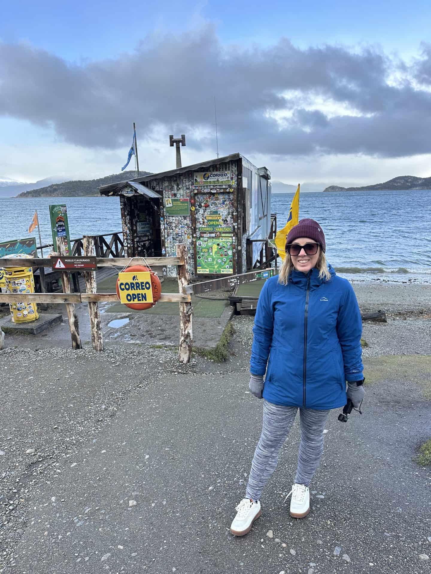 carli standing in front of the southernmost post office located in Tierra Del Sol national park in Argentina