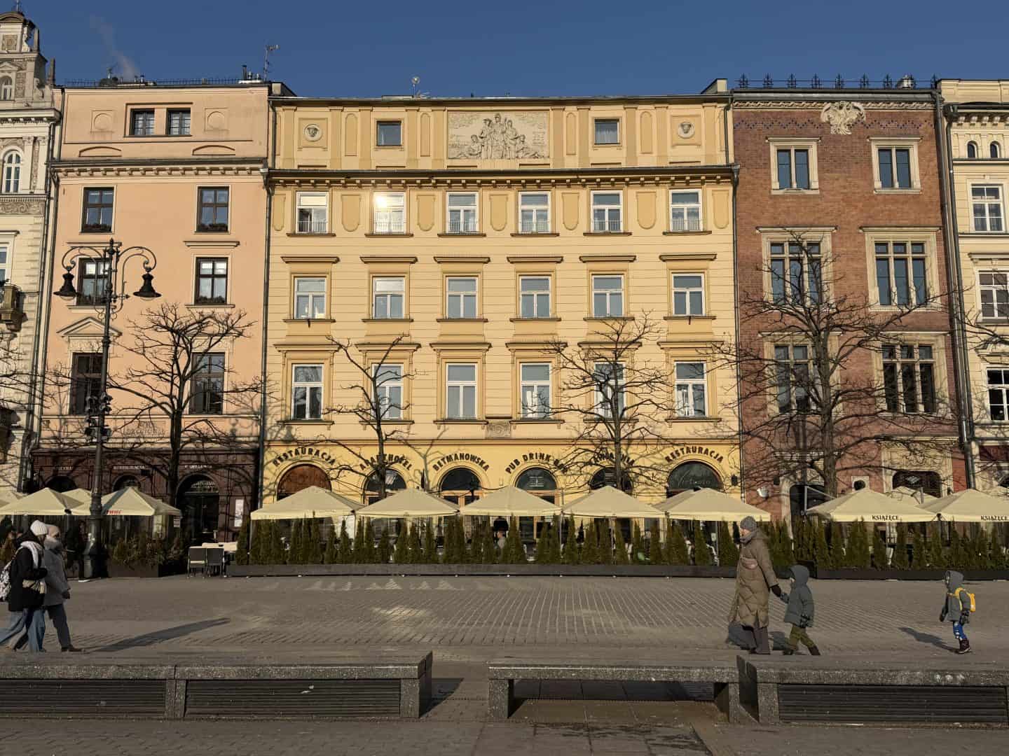 different colored buildings along Rynek Glowny square in Krakow