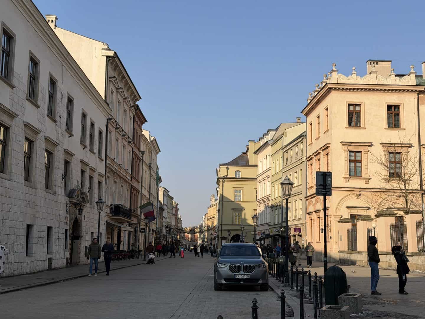 looking down the street with soft pastel colored buildings on either side