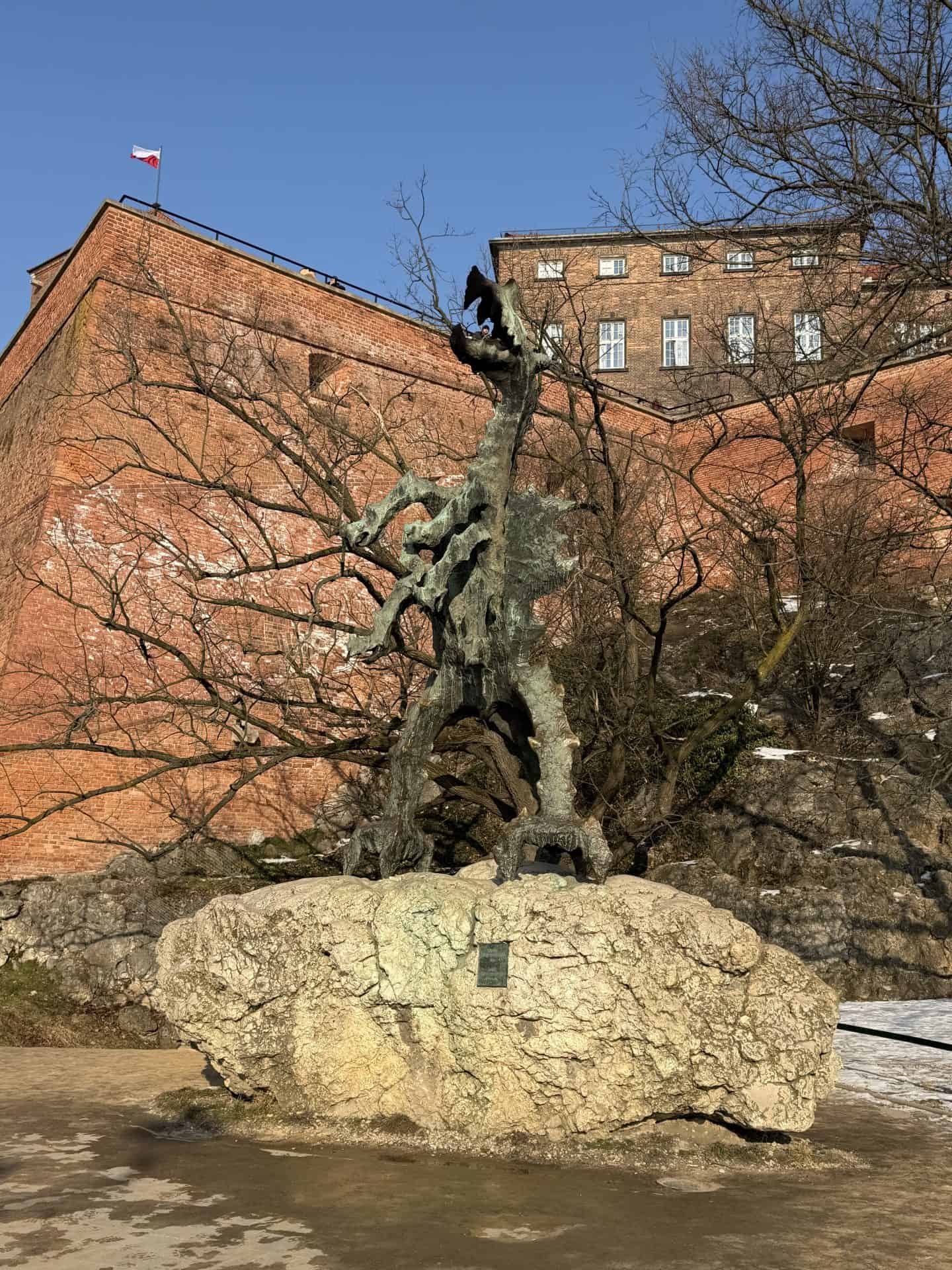 dragon statue with wawel castle in the background