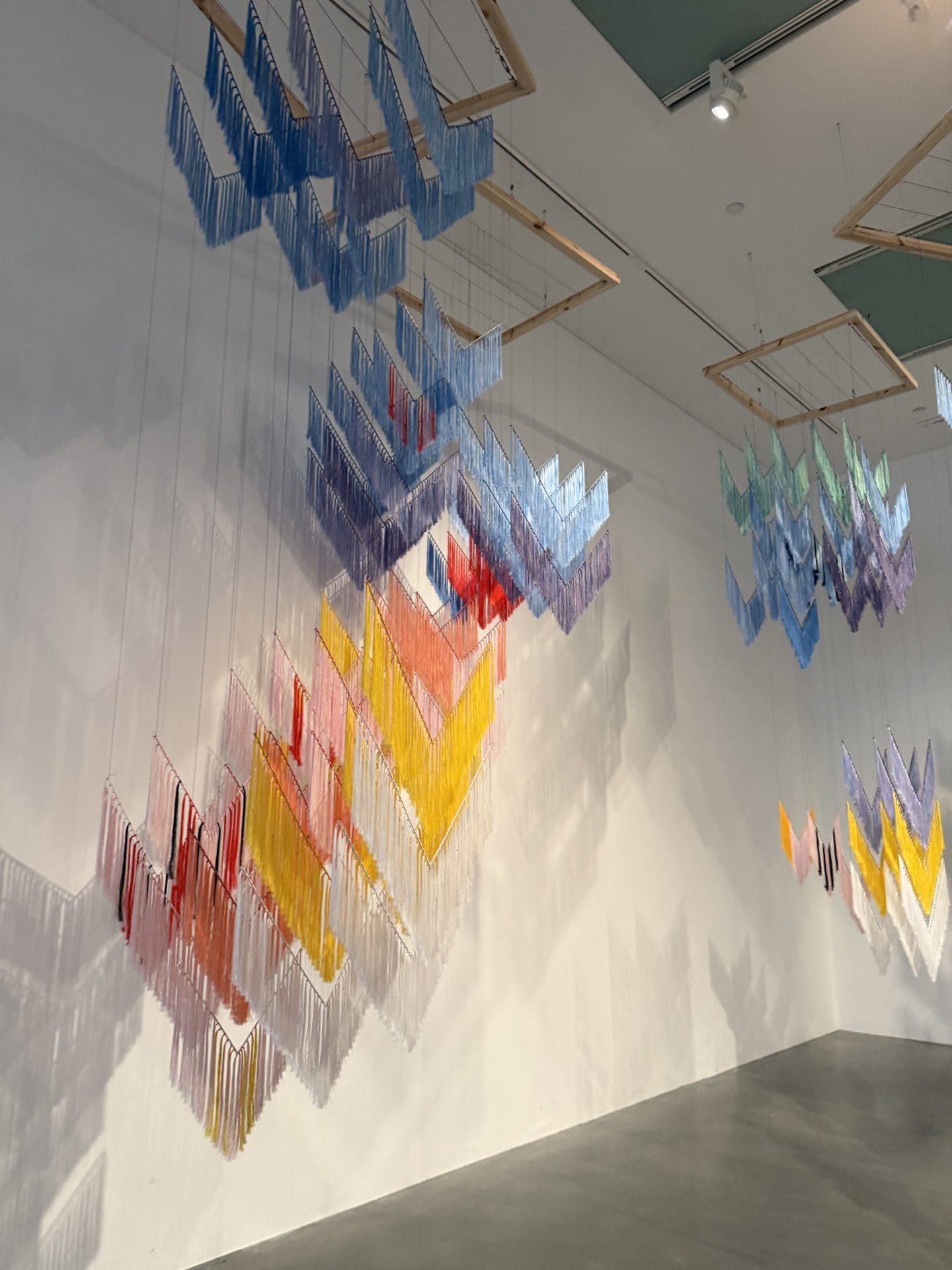 hanging textile mobiles in different colors at tate modern art museum in london