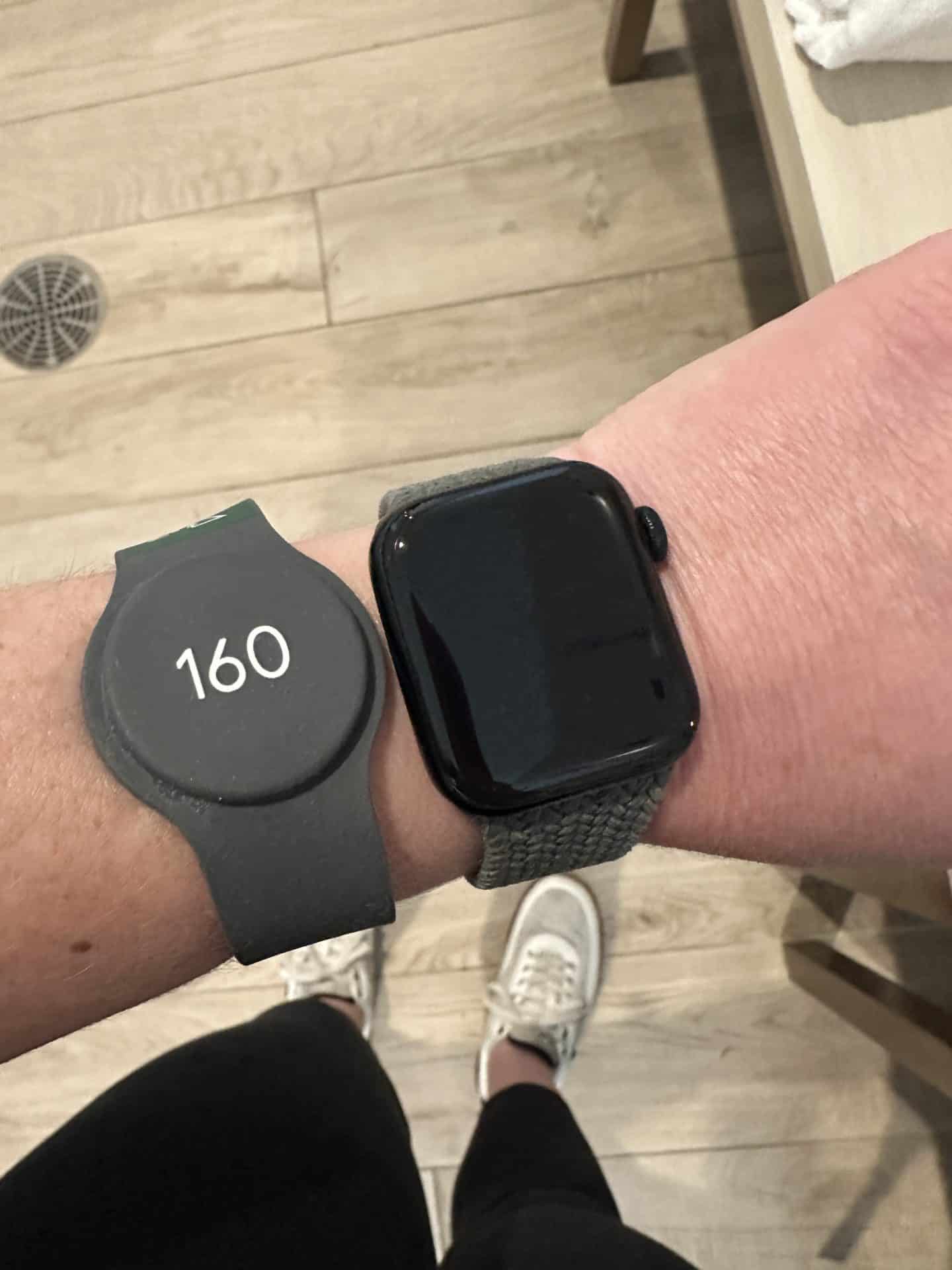 photo of spa electronic wristband next to apple watch