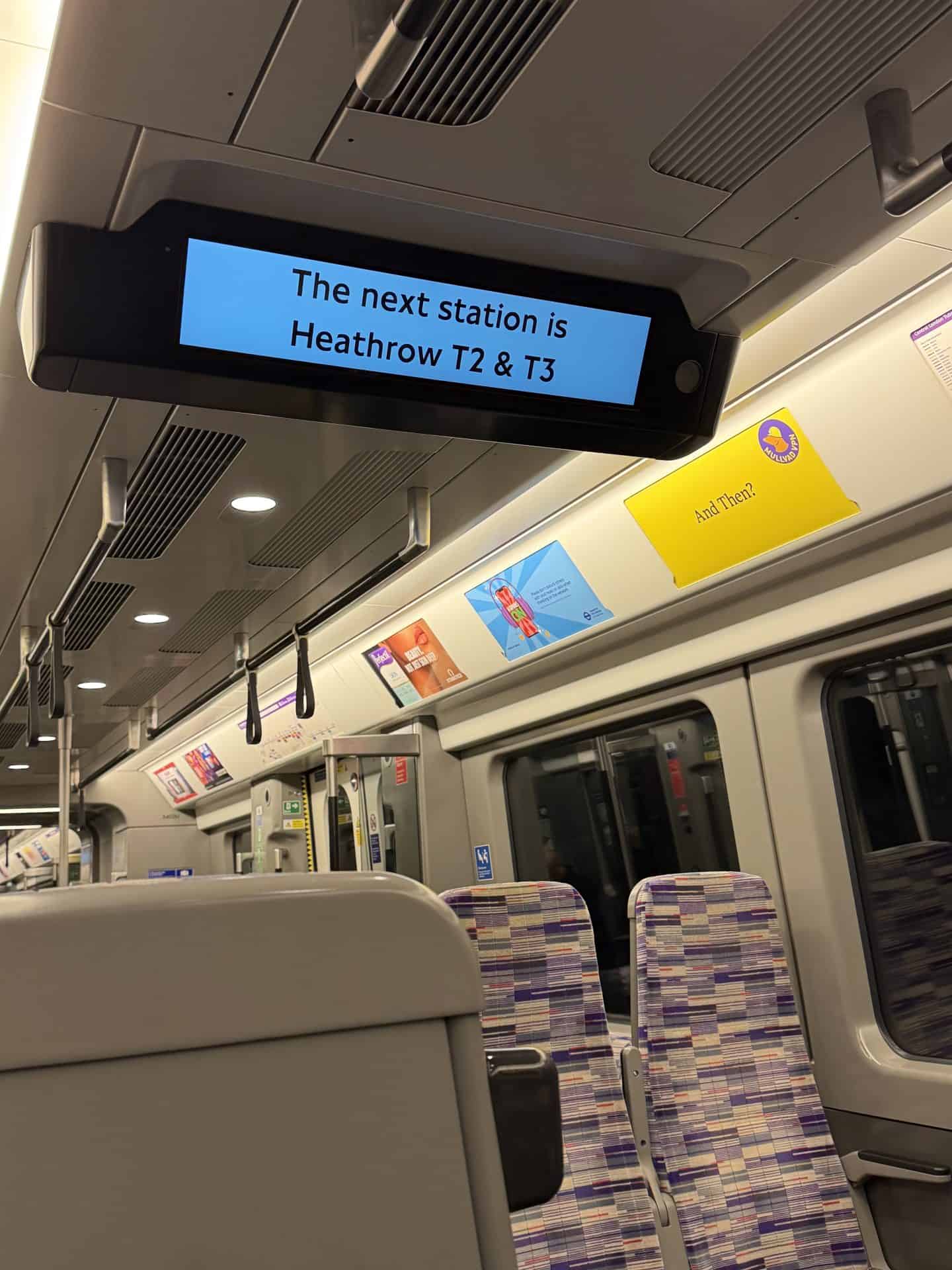 interior of heathrow airport terminal train with sign reading next station heathrow T2 & T3