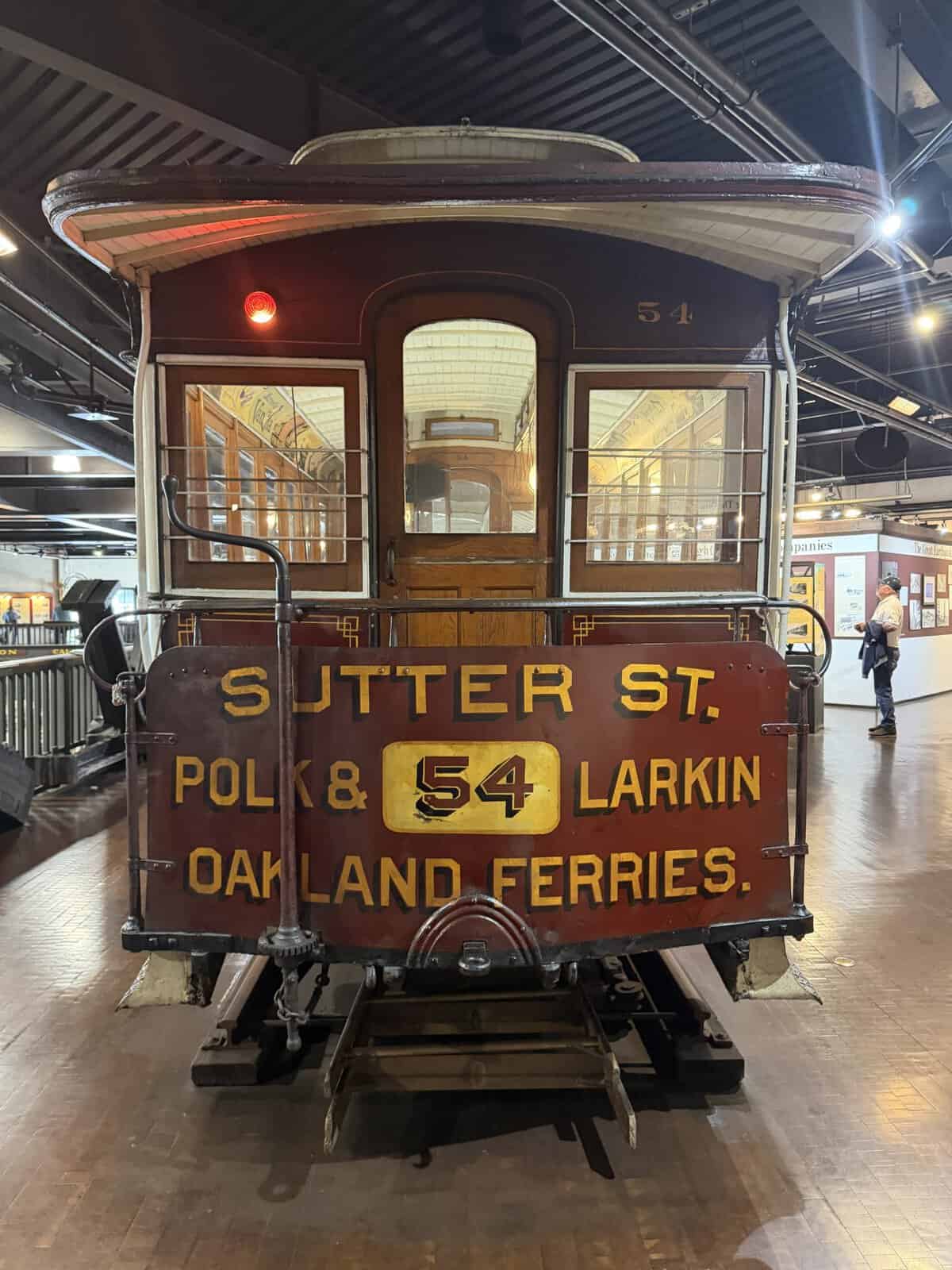 back end of san francisco cable car reading sutter street and oakland ferries on wood