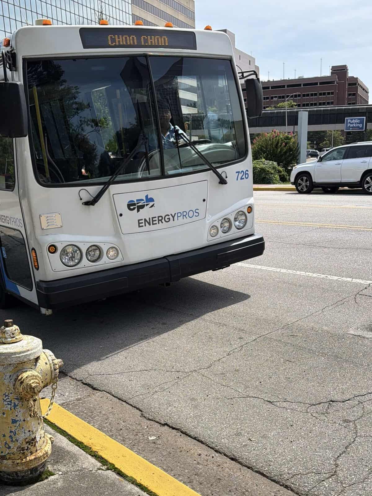 white chattanooga shuttle bus pulling up to curb