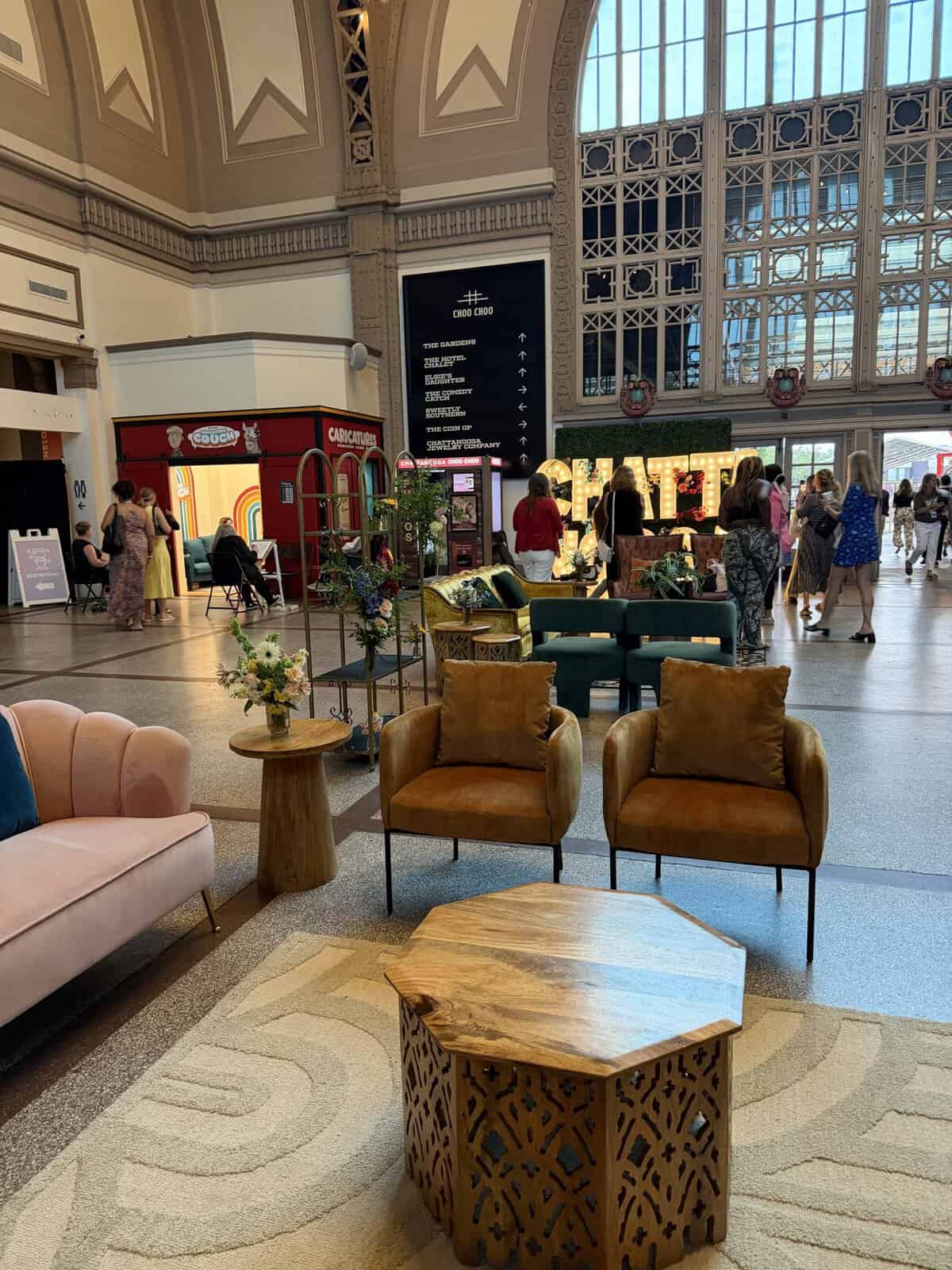 lobby of chattanooga choo choo with gold velvet chairs, blush pink velvet sofa, and small wood tables in foreground