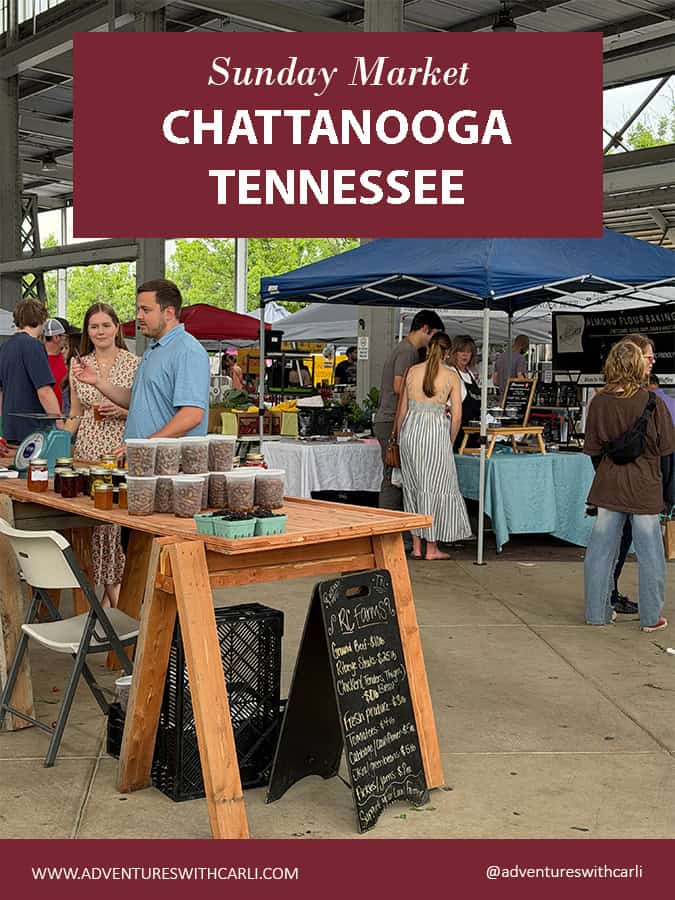 Outdoor Sunday Market scene in Chattanooga, Tennessee with vendors under tents and jars displayed on a wooden table in the foreground.
