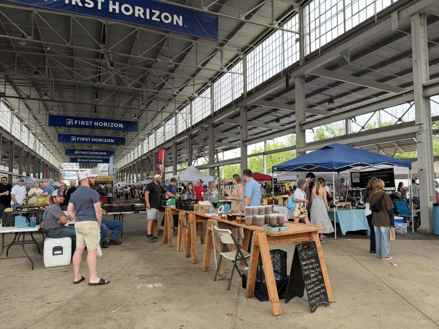 large open pavillion with booths and stands at chattanooga market