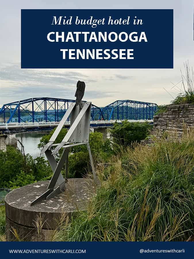 poster reading mid budget hotel in chattanooga. photo of seated metal man sculpture in foreground and bridge over tennessee river in background