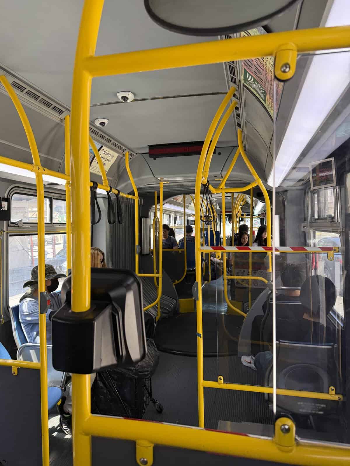 interior of san francisco bus with railings painted bright yellow